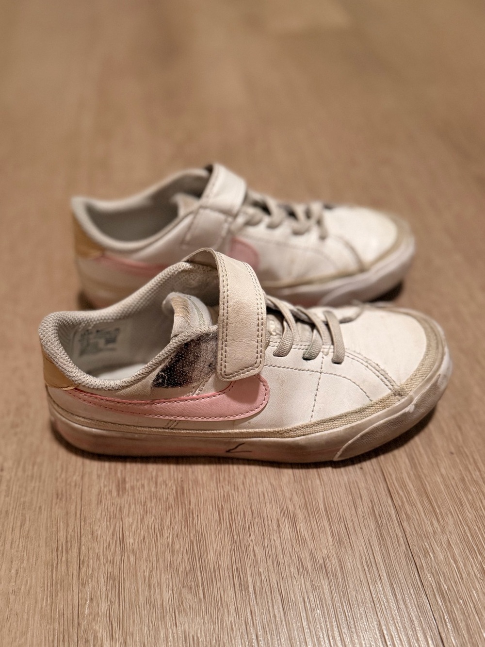 Nike Kids White Sneakers with Pink Swoosh and Gold Heel